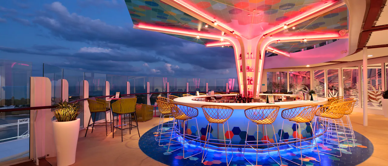 Enjoy a cocktail in The Vue Bar - the bar has a colorful mosaic canopy overhead after sunset