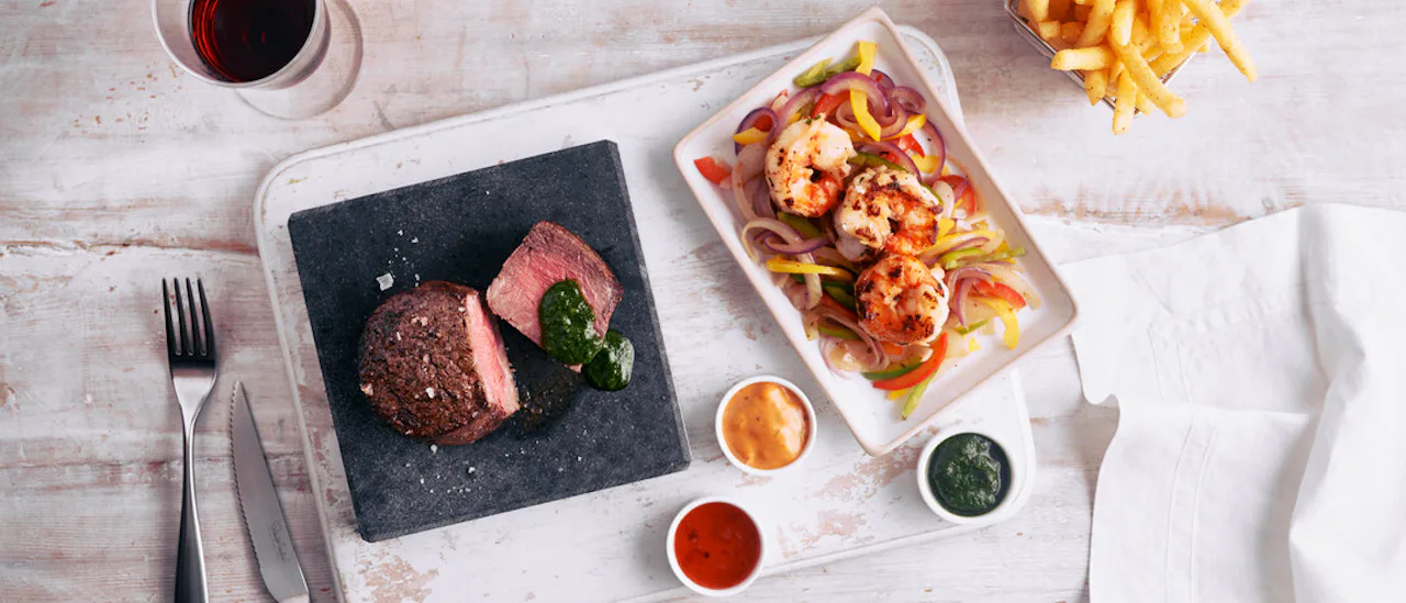 Tuck into American influenced speciality dishes in a fun and informal setting at The Beach House